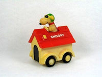 Snoopy rides on doghouse